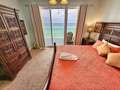 a bedroom with a bed with a view of the ocean at Tropic Winds 701 in Panama City Beach