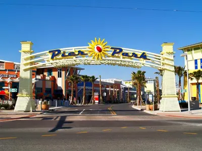 a large sign for a theme park on a street at Tropic Winds 701 in Panama City Beach