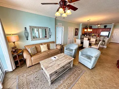 a living room with a couch and a table at Tropic Winds 701 in Panama City Beach