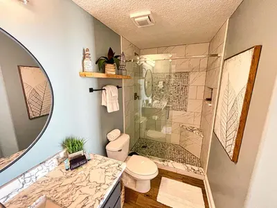 a bathroom with a shower and a toilet and a sink at Tropic Winds 2005 in Panama City Beach