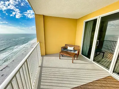 a balcony with a bench and the ocean at Tropic Winds 2005 in Panama City Beach