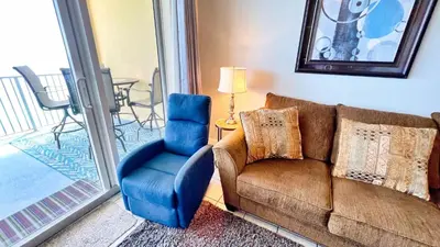 a living room with a couch and a chair at Tropic Winds 2105 in Panama City Beach