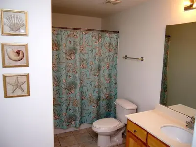 a bathroom with a shower curtain and a toilet at Tropic Winds 2105 in Panama City Beach