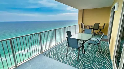 a balcony with a table and chairs and the ocean at Tropic Winds 2105 in Panama City Beach