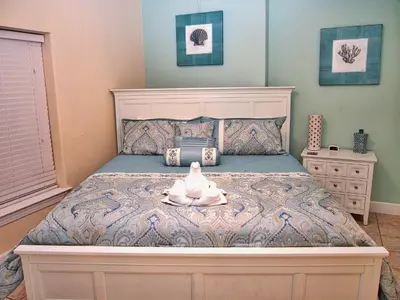 a bedroom with a bed with a stuffed animal on it at Tropic Winds 2105 in Panama City Beach