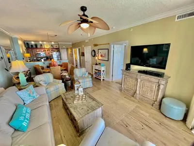 a living room with a couch and a flat screen tv at Ocean Reef 1407 in Panama City Beach