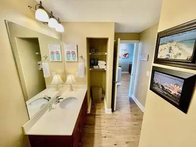 a bathroom with a sink and a large mirror at Ocean Reef 1407 in Panama City Beach