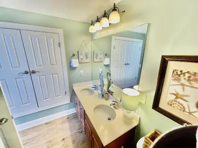 a bathroom with a sink and a mirror at Ocean Reef 1407 in Panama City Beach