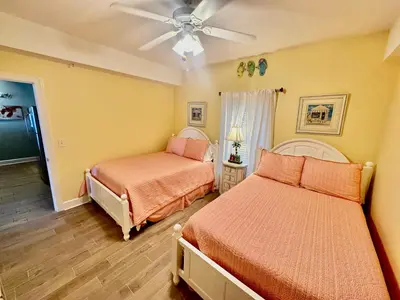 a bedroom with two beds and a ceiling fan at Ocean Reef 1407 in Panama City Beach