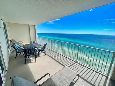 a balcony with a table and chairs and the ocean at Ocean Reef 1802 in Panama City Beach