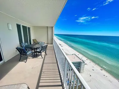 a balcony with a table and chairs on the beach at Ocean Reef 1802 in Panama City Beach
