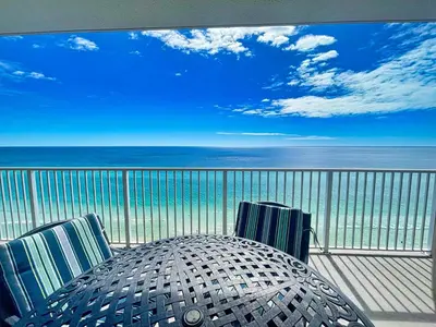 a table and chairs on a balcony with the ocean at Ocean Reef 1802 in Panama City Beach
