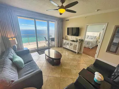 a living room with a couch and a view of the ocean at Ocean Reef 1802 in Panama City Beach