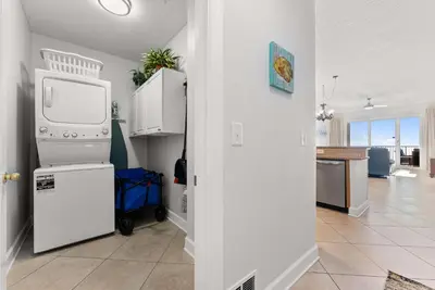 a kitchen with a refrigerator and a microwave at Ocean Reef 1904 in Panama City Beach