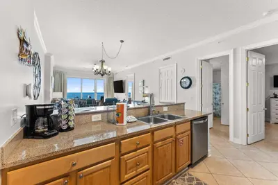 a kitchen with a sink and a counter top at Ocean Reef 1904 in Panama City Beach