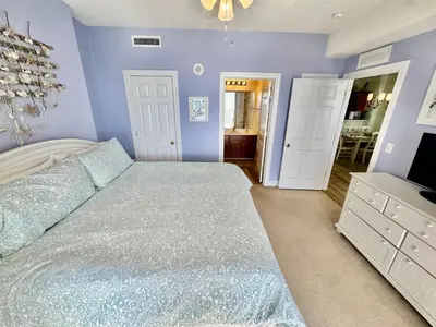 a bedroom with a large bed and a television at Tropic Winds 1904 in Panama City Beach