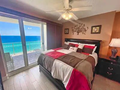 a bedroom with a bed with a view of the ocean at Ocean Reef 1608 in Panama City Beach