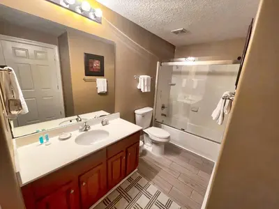 a bathroom with a sink and a toilet and a shower at Ocean Reef 1608 in Panama City Beach