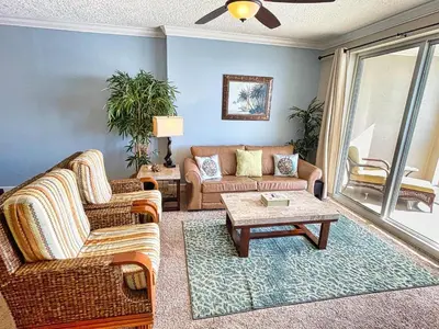 a living room with two couches and a coffee table at Ocean Reef 1202 in Panama City Beach