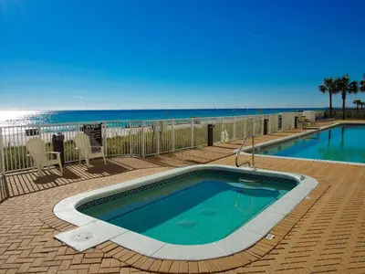 a swimming pool with the beach in the background at Ocean Reef 1202 in Panama City Beach
