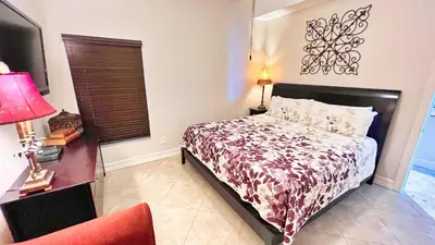 a bedroom with a bed and a table and a chair at Ocean Reef 2101 in Panama City Beach
