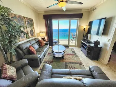 a living room with a couch and a flat screen tv at Ocean Reef 2101 in Panama City Beach