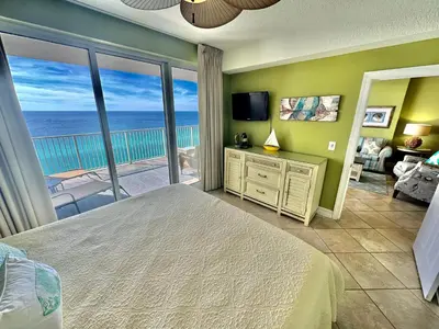 a bedroom with a bed and a view of the ocean at Ocean Reef 1707 in Panama City Beach