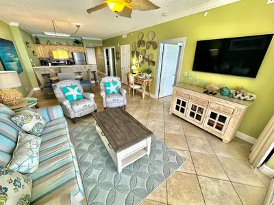 a living room with a large flat screen tv at Ocean Reef 1707 in Panama City Beach