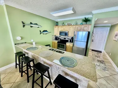 a kitchen with a large island with a counter top at Ocean Reef 1707 in Panama City Beach