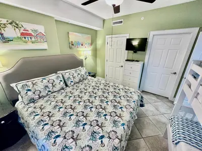 a bedroom with a bed and a flat screen tv at Ocean Reef 1707 in Panama City Beach