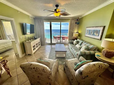 a living room with a couch and chairs and a television at Ocean Reef 1707 in Panama City Beach