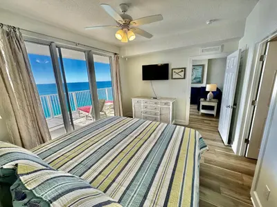 a bedroom with a bed and a view of the ocean at Tropic Winds 2305 in Panama City Beach