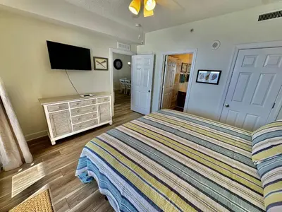 a bedroom with a bed and a flat screen tv at Tropic Winds 2305 in Panama City Beach