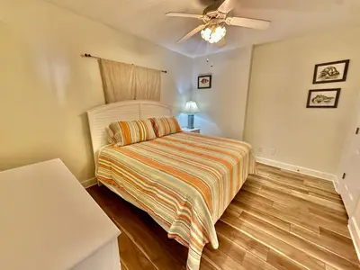 a bedroom with a bed and a ceiling fan at Tropic Winds 2305 in Panama City Beach