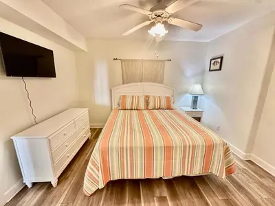 a bedroom with a bed and a ceiling fan at Tropic Winds 2305 in Panama City Beach