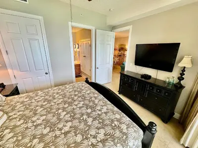 a bedroom with a bed and a flat screen tv at Ocean Reef 2001 in Panama City Beach
