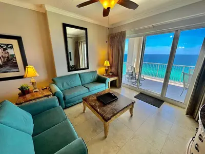 a living room with blue furniture and a view of the ocean at Ocean Reef 2001 in Panama City Beach