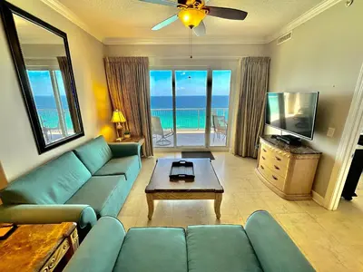 a living room with a blue couch and a television at Ocean Reef 2001 in Panama City Beach