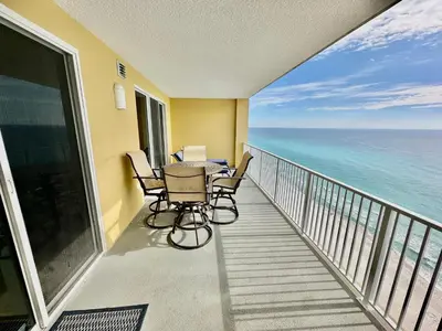 a balcony with a table and chairs and the ocean at Tropic Winds 1705 in Panama City Beach