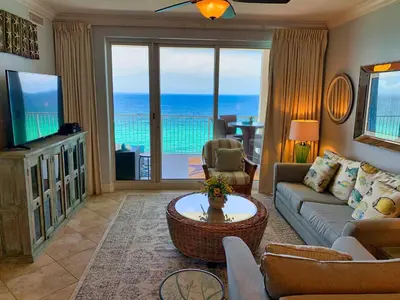 a living room with a view of the ocean at Ocean Reef 1403 in Panama City Beach