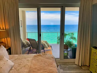 a bedroom with a view of the ocean at Ocean Reef 1403 in Panama City Beach