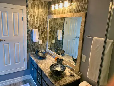 a bathroom with a sink and a large mirror at Ocean Reef 1403 in Panama City Beach