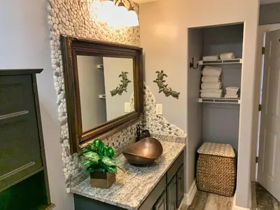 a bathroom with a sink and a mirror at Ocean Reef 1403 in Panama City Beach
