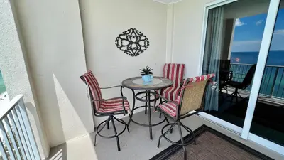 a balcony with a table and chairs on a balcony at Ocean Reef 1803 in Panama City Beach