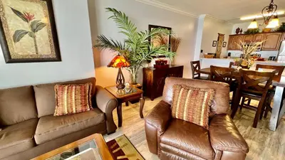 a living room with two couches and a dining room at Ocean Reef 1803 in Panama City Beach