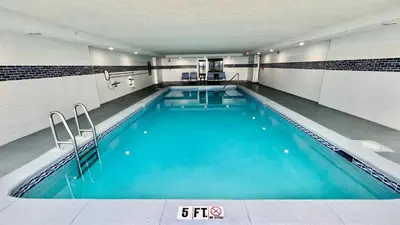 a large swimming pool with blue water in a building at Ocean Reef 1803 in Panama City Beach