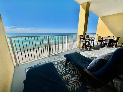 a balcony with a couch and a view of the ocean at Tropic Winds 702 in Panama City Beach