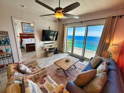 a living room with a couch and a view of the ocean at Ocean Reef 2303 in Panama City Beach