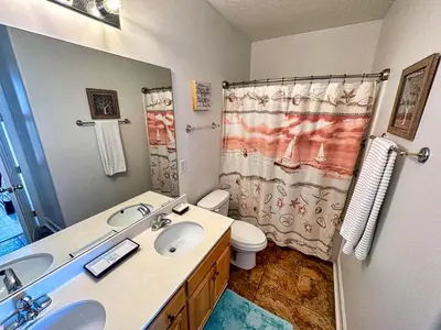 a bathroom with a sink and a toilet and a shower at Ocean Reef 2303 in Panama City Beach