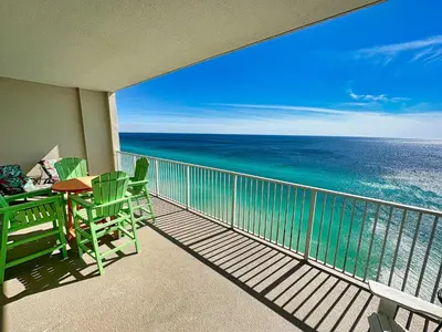 a balcony with a table and chairs and the ocean at Ocean Reef 2303 in Panama City Beach